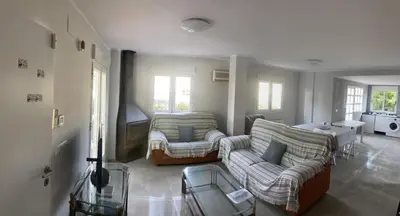 a living room with two couches and a tv at Casa Las Emilias en La Cañada in Partida de La Cañada