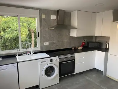 a kitchen with a washing machine and a sink at Casa Las Emilias en La Cañada in Partida de La Cañada