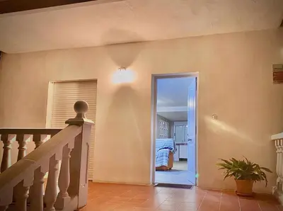 a hallway with a staircase leading to a bedroom at Casa Las Emilias en La Cañada in Partida de La Cañada