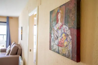 a painting of a woman hanging on a wall at ESPACIO 18 - Primera Línea de Playa in Cullera