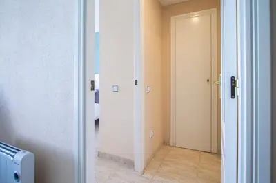 a hallway with a door leading into a room at ESPACIO 18 - Primera Línea de Playa in Cullera