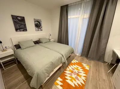 a bedroom with a large bed and a window at Precioso apartamento con patio. PYP in Valencia