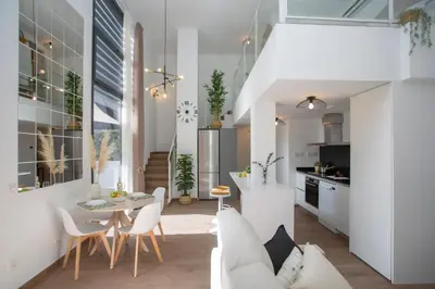 a living room with a white couch and a table at SingularStays Arena in Valencia