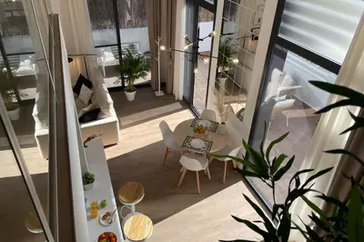 an apartment with a balcony with a table and chairs at SingularStays Arena in Valencia