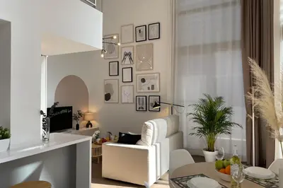 a living room with a white couch and a table at SingularStays Arena in Valencia