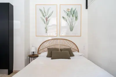 a bedroom with a bed with two pictures on the wall at Estudio Baleares Apartamento n3 in Valencia