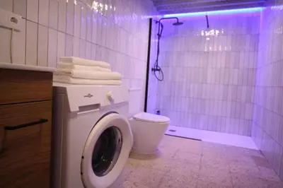 a bathroom with a toilet and a shower with purple lights at Estudio Baleares Apartamento n3 in Valencia