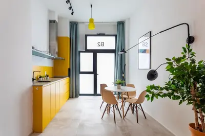 a kitchen with a table and chairs and a yellow cabinet at CHARMING LOFT IN RUZAFA, SOHO b2 in Valencia