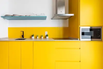 a kitchen with yellow cabinets and a microwave at CHARMING LOFT IN RUZAFA, SOHO b2 in Valencia