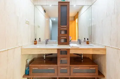 a bathroom with two sinks and a large mirror at Penthouse Duplex in a 4 floors spanish house -8 min to center by Metro in Valencia