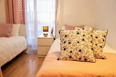 a bedroom with a bed with two pillows and a window at Penthouse Duplex in a 4 floors spanish house -8 min to center by Metro in Valencia