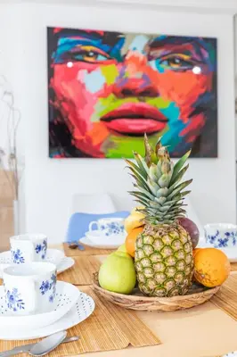 a bowl of fruit on a table with a painting at Penthouse Duplex in a 4 floors spanish house -8 min to center by Metro in Valencia