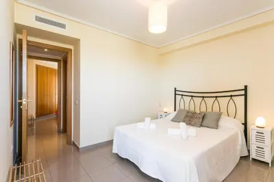 a bedroom with a large bed in a room at ApartUP Patacona Orchard Views in Valencia