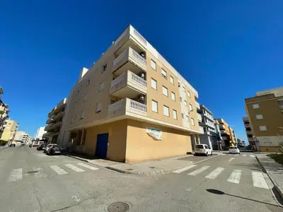 a tall apartment building on a city street at Apartamento Grao de Moncofar REF. 041 in Moncófar
