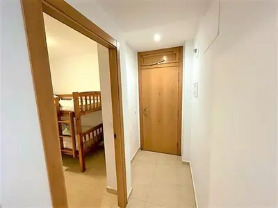 a hallway with a door leading to a room at Apartamento Grao de Moncofar REF. 041 in Moncófar