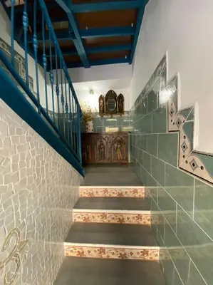 a staircase in a house with a blue railing at La carchata 1 in Siete Aguas