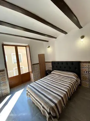 a bedroom with a large bed in a room at La carchata 1 in Siete Aguas