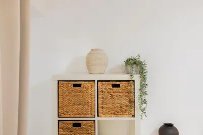 a shelf with baskets and a vase on top at Your Sunny & Spacious Portview Home in Valencia