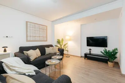 a living room with a couch and a tv at Your Sunny & Spacious Portview Home in Valencia