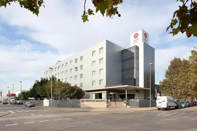 a building with a van parked in front of it at Exe Puerto de Sagunto in Puerto de Sagunto