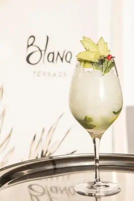 a drink in a martini glass on a tray at Blanq Carmen Hotel in Valencia