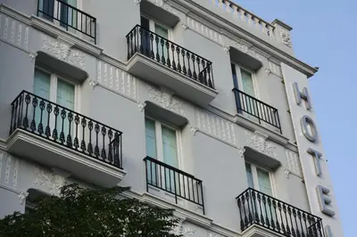 a building with balconies and a clock on the side of it at Blanq Carmen Hotel in Valencia