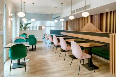 a row of tables and chairs in a restaurant at Blanq Carmen Hotel in Valencia