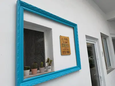 a bedroom with a bed and a blue curtain at Rooms Burjassot in Burjasot