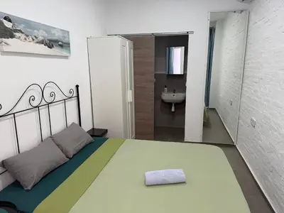 a bedroom with a bed in a white room at Rooms Burjassot in Burjasot