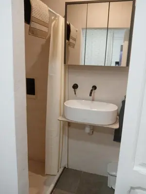 a bathroom with a white sink and a toilet at Rooms Burjassot in Burjasot