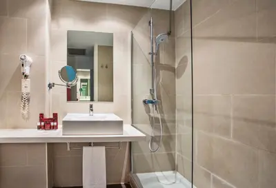 a bathroom with a sink and a shower at AZZ Valencia Táctica Hotel in Paterna