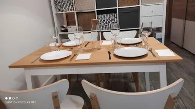 a dining room table with glasses and plates on it at APARTMENTSUITESPAIN PLAYA - UNIVERSIDADes in Valencia