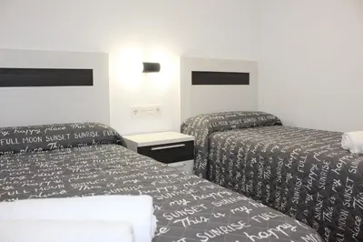 a hotel room with two beds in a room at Apartamento a pie de playa in Cullera
