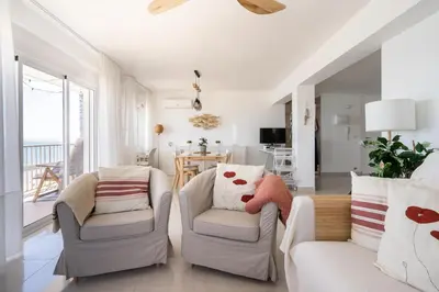a balcony with chairs and a table and the beach at El Acuario - Primera línea y todas las ventanas dan al mar in Cullera