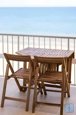 a room with a desk with a television and a chair at El Acuario - Primera línea y todas las ventanas dan al mar in Cullera