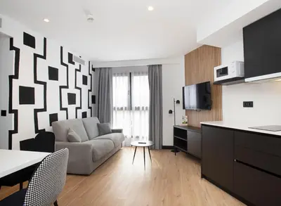 a living room with a couch and a table at Sercotel Plana Suites in Vall de Uixó