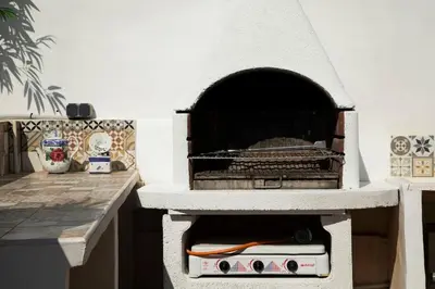 a kitchen with an outdoor oven in a room at APARTAMENTO CON TERRAZA Y BARBACOA in Paterna