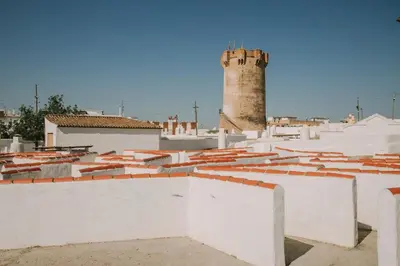 a view of the roofs of a city with a lighthouse at APARTAMENTO CON TERRAZA Y BARBACOA in Paterna