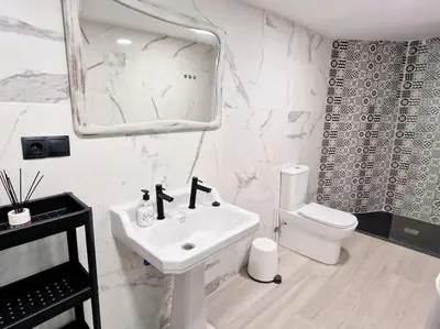 a white bathroom with a sink and a toilet at APARTAMENTO CON TERRAZA Y BARBACOA in Paterna