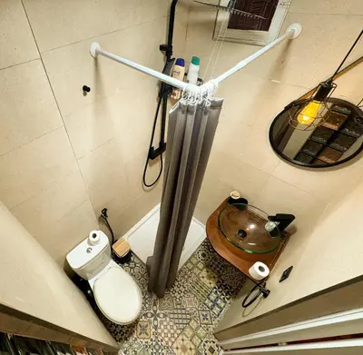 a bathroom with a shower and a toilet and a mirror at Apartamento con encanto histórico in Valencia