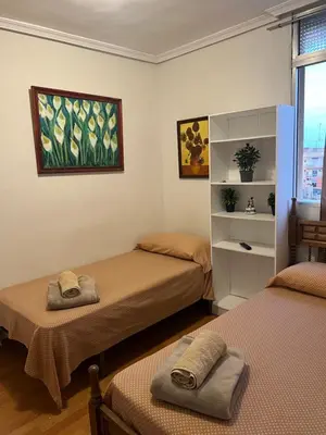 a room with two beds with towels on them at Malvarrosa habitación cómoda y sencilla cerca de la playa in Valencia