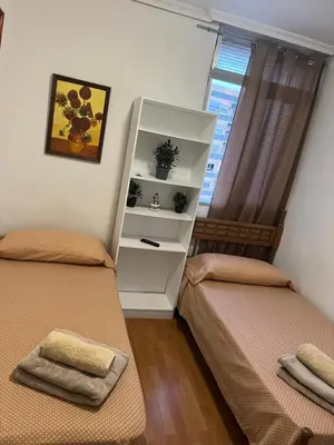 a bedroom with two beds and a white cabinet at Malvarrosa habitación cómoda y sencilla cerca de la playa in Valencia