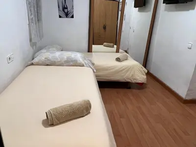 two beds in a dorm room with a towel on the bed at Malvarrosa habitación cómoda y sencilla cerca de la playa in Valencia