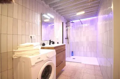 a washing machine in a bathroom with a shower at Apartamento Menorca Apartamento n1 in Valencia