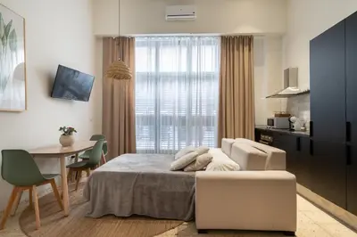 a bedroom with a bed and a table and a dining room at Apartamento Menorca Apartamento n1 in Valencia