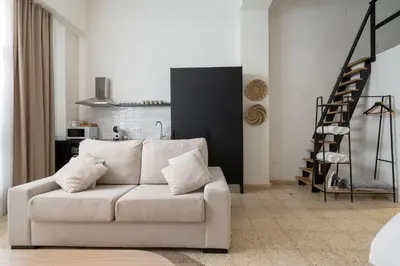 a living room with a white couch and a staircase at Apartamento Menorca Apartamento n1 in Valencia
