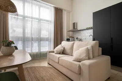 a living room with a white couch and a table at Apartamento Menorca Apartamento n1 in Valencia