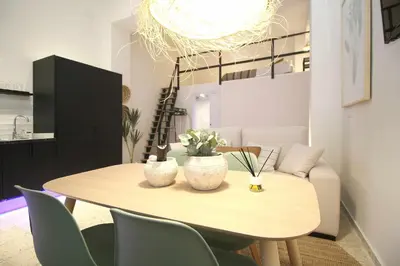 a dining room table with chairs and a chandelier at Apartamento Menorca Apartamento n1 in Valencia