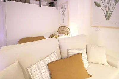 a room with a white couch and a bed at Loft Ibiza Apartamento n2 in Valencia