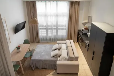 a living room with a bed and a table and a dining room at Loft Ibiza Apartamento n2 in Valencia